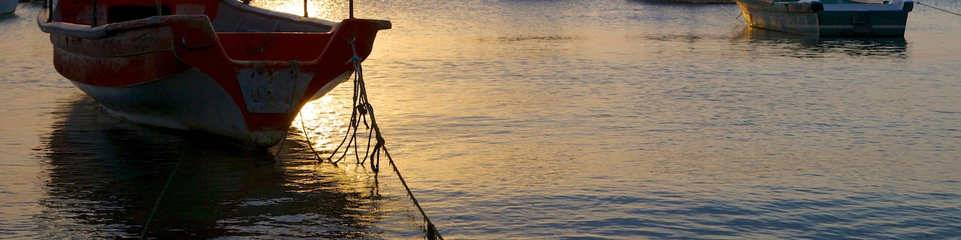 Taganga Beach featuring general coastal views, a sunset and a bay or harbor