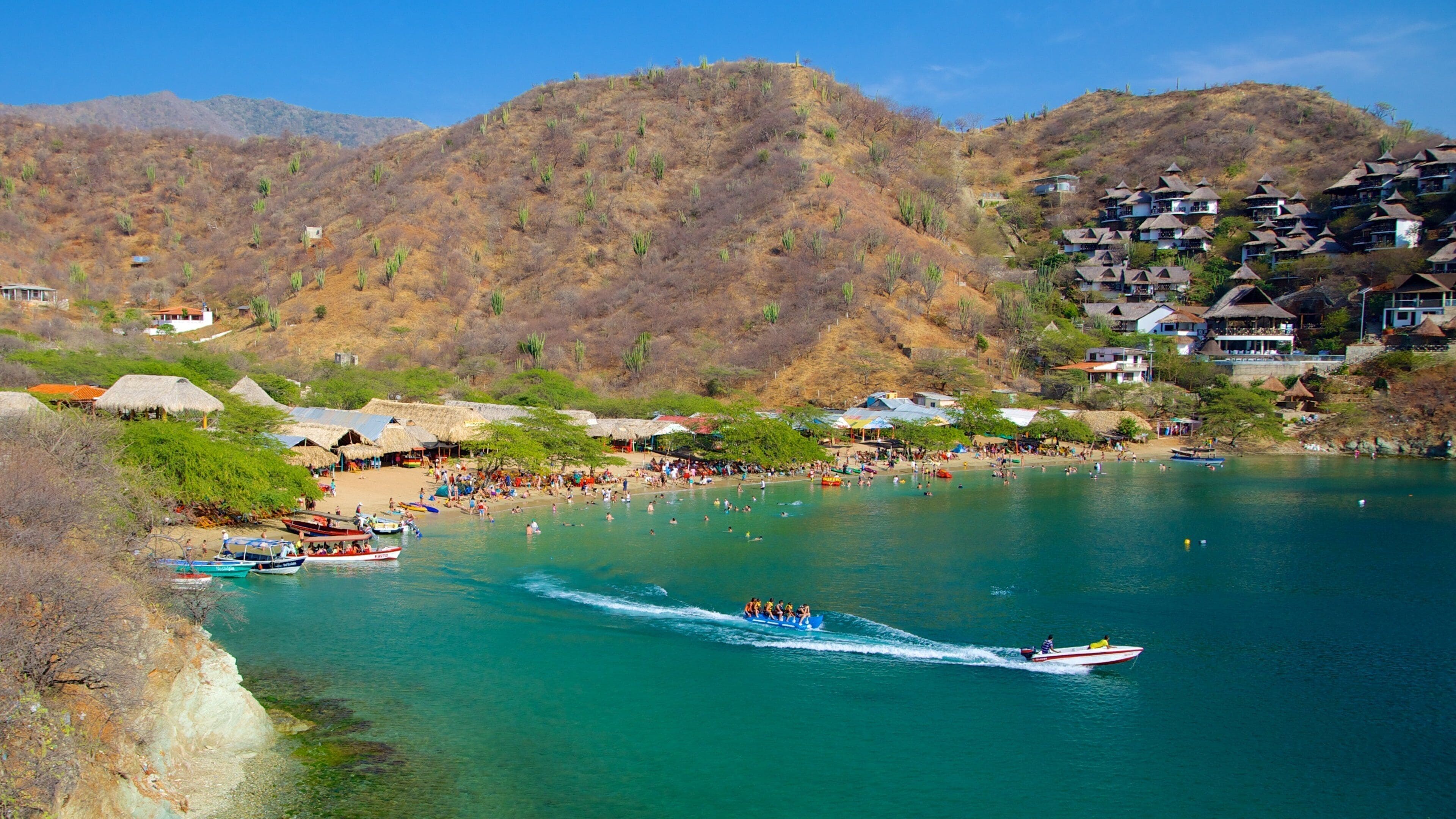 Taganga Beach which includes a beach, boating and a bay or harbor