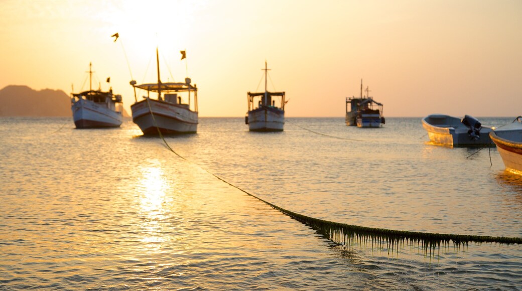 Taganga Beach which includes boating, a bay or harbor and a sunset