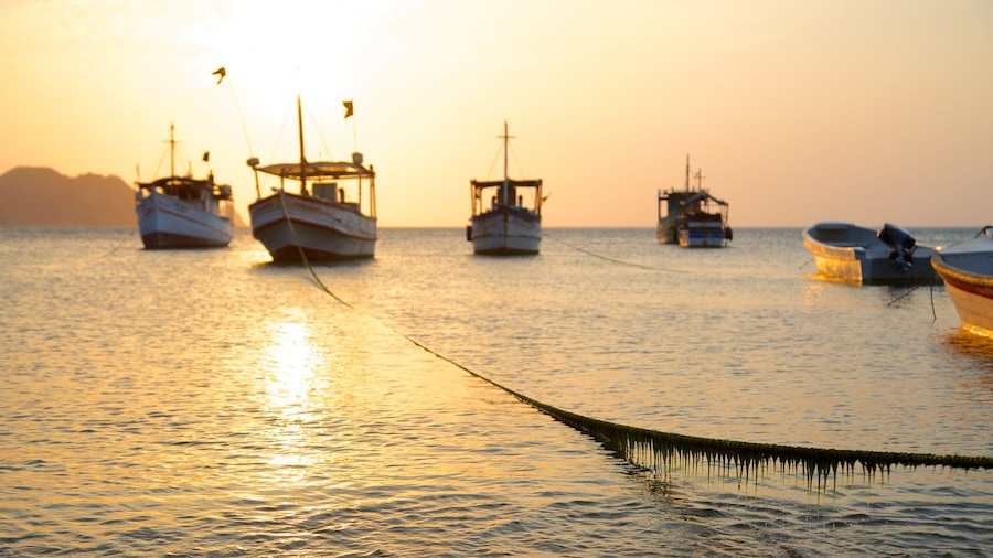 Taganga Beach which includes boating, a bay or harbor and a sunset