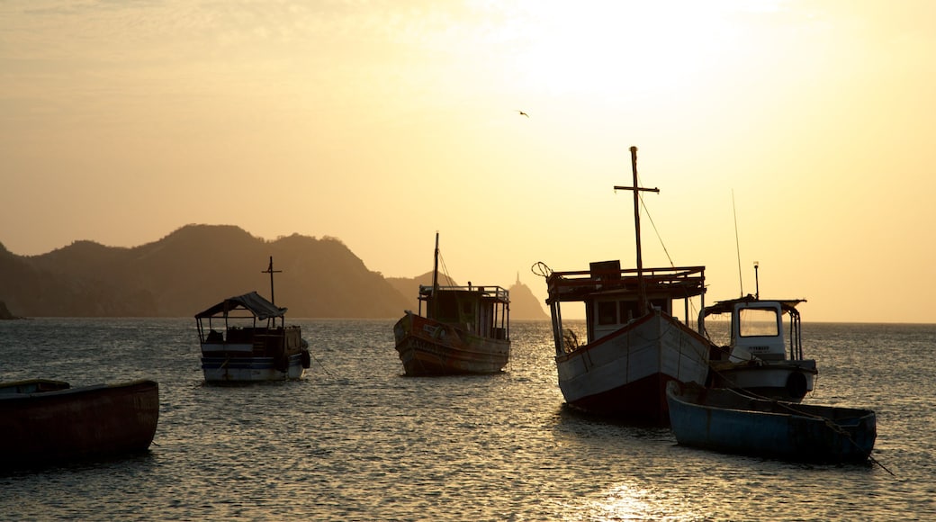 Playa Taganga ofreciendo un atardecer, una bahía o un puerto y botes