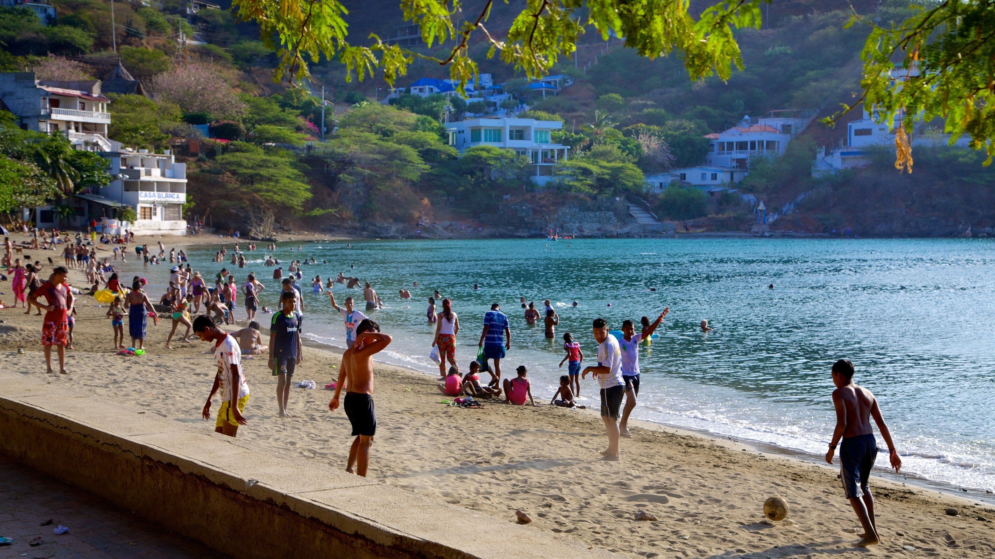 Taganga Beach which includes a coastal town, swimming and a sandy beach
