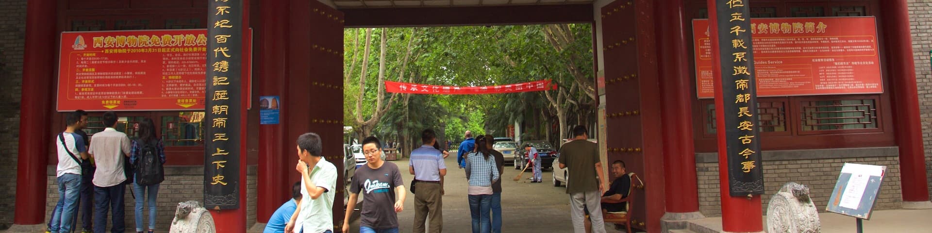 Giant Wild Goose Pagoda which includes a temple or place of worship and signage as well as a small group of people