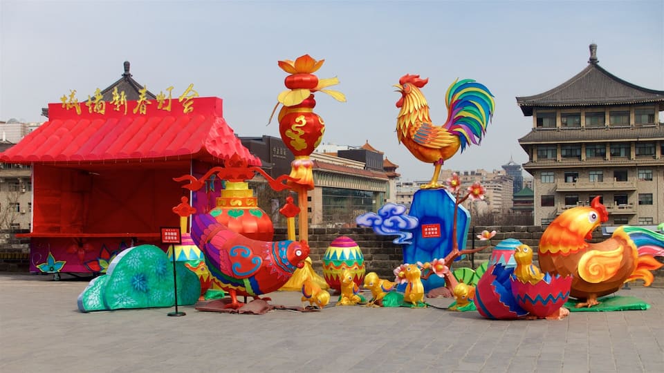 A colorful display of traditional Chinese lanterns and sculptures in an urban setting.