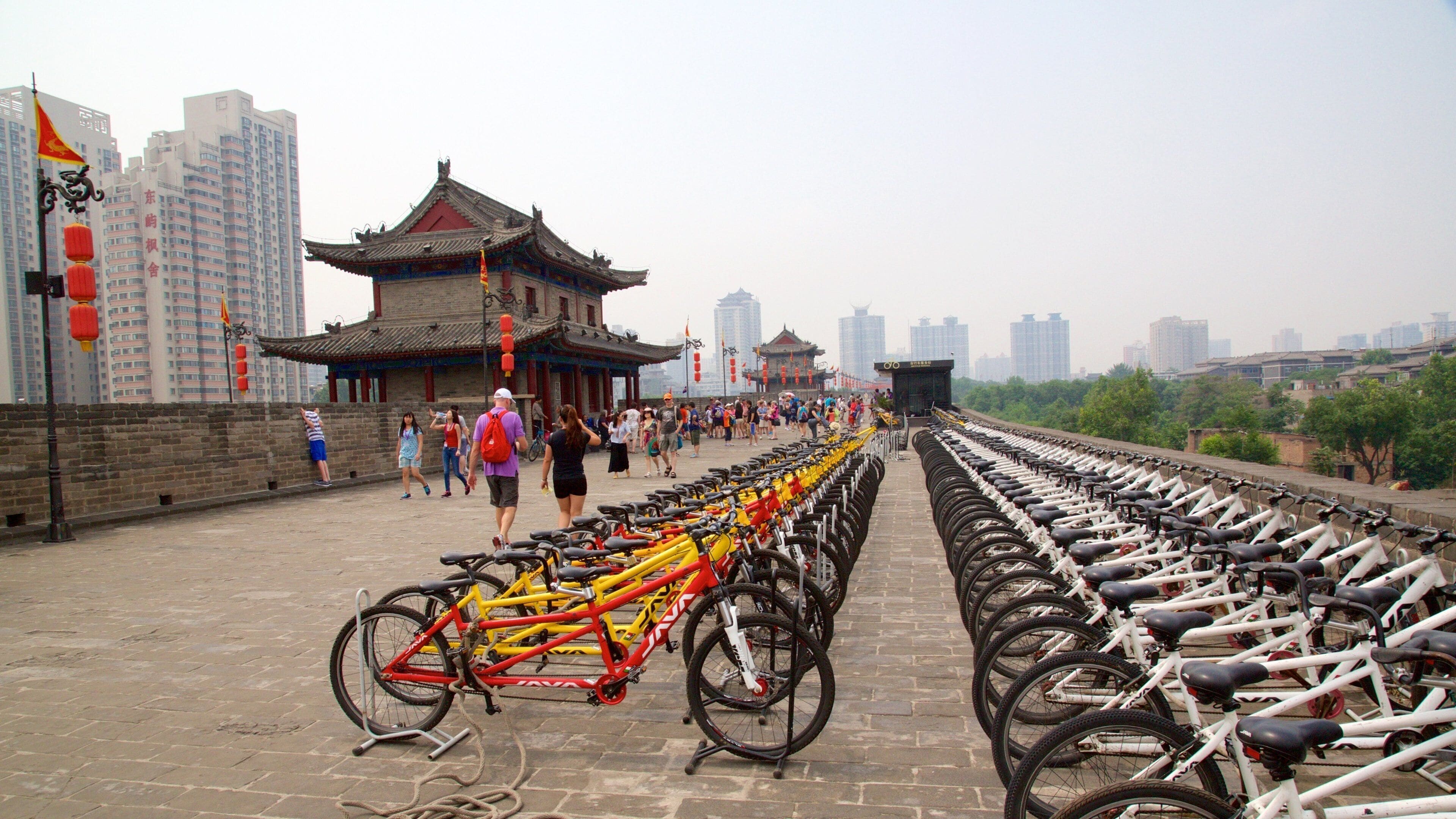 Xi\'an City Walls showing cycling and a city as well as a large group of people