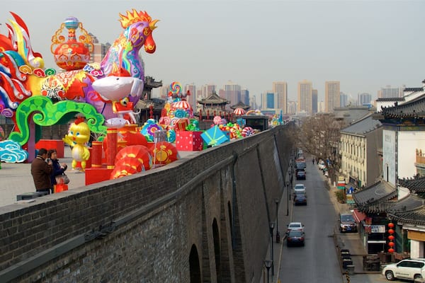 A street lined with traditional architecture and a vibrant display of colorful lanterns and decorations.