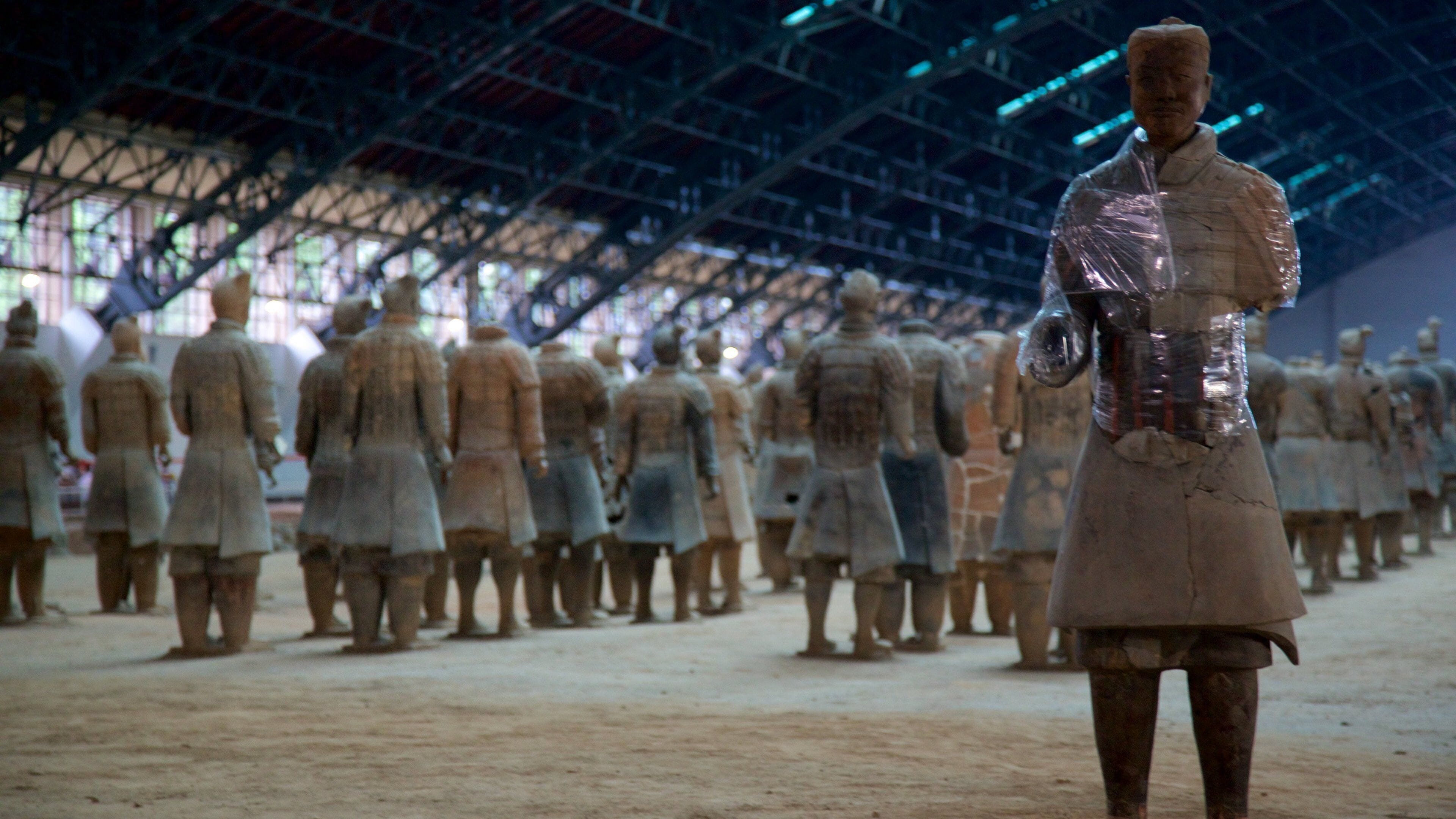 A terracotta army statue in a museum.