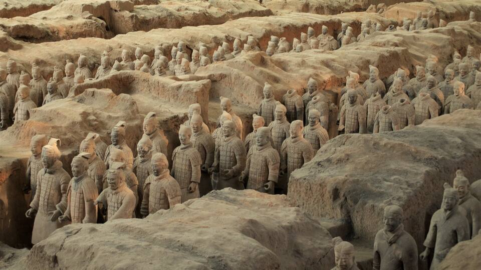 A large number of terracotta warrior statues arranged in rows.