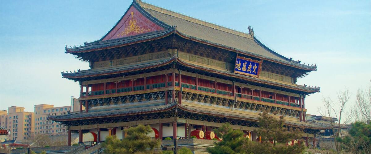 A traditional multi-tiered building with ornate decorations and a red roof.