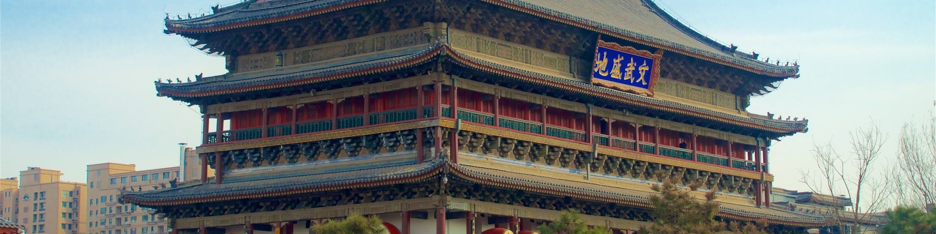A traditional multi-tiered building with ornate decorations and a red roof.