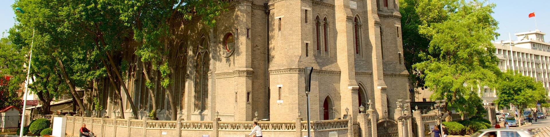 A historic church with a tall bell tower and arched windows.