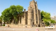 A historic church with a tall bell tower and arched windows.