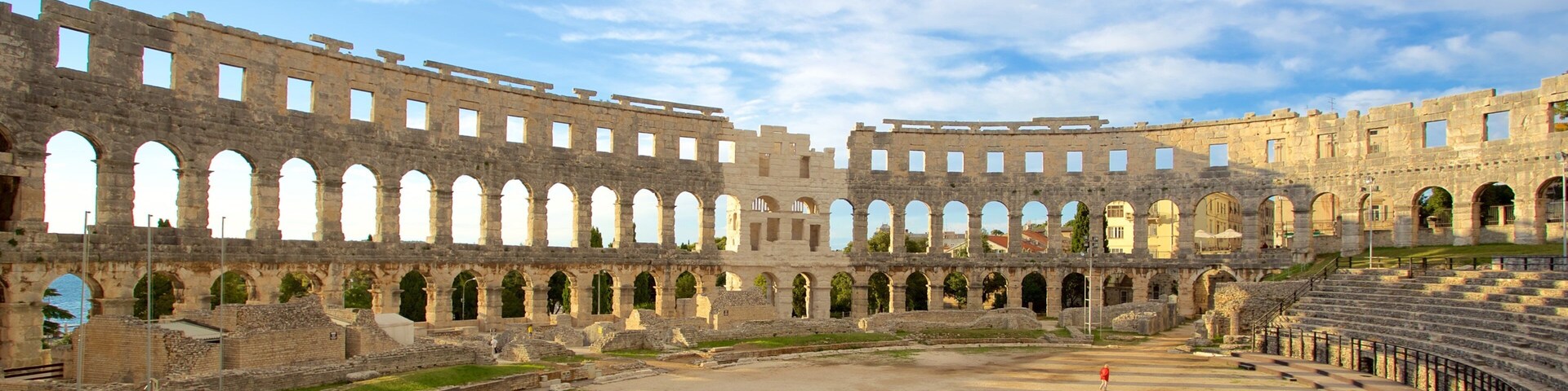 Pula Arena which includes a monument, heritage elements and building ruins
