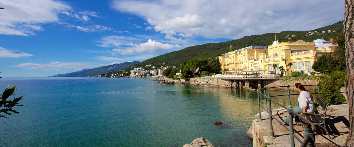 A coastal town with clear blue waters, a pier, and a prominent yellow building with 'YARNER' on it.