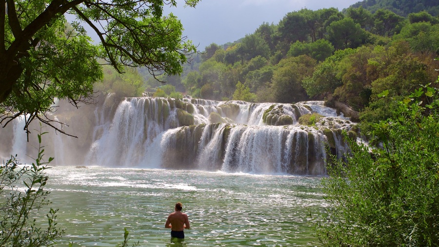 Krka National Park showing a lake or waterhole and rapids as well as an individual male