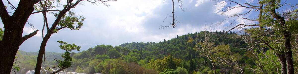 Krka National Park featuring rapids and a lake or waterhole as well as a small group of people