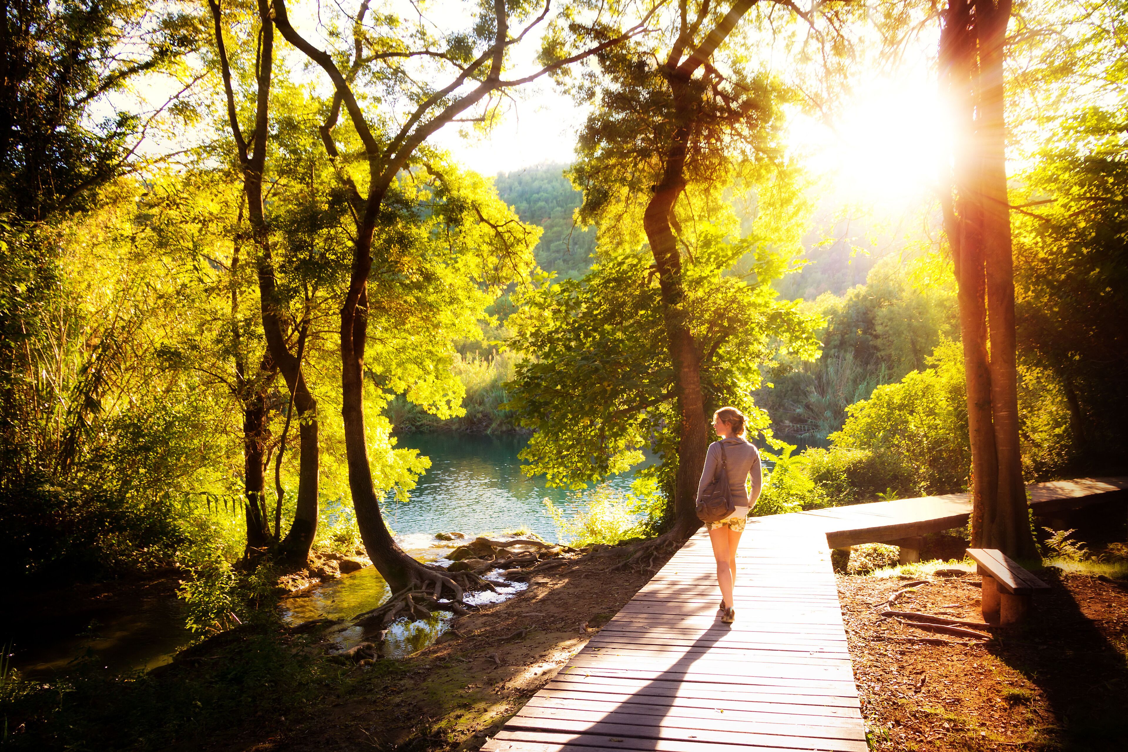 Beautiful young woman walks in Krka national park in Croatia at sunset