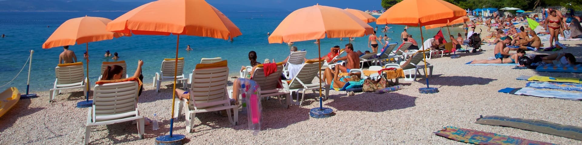 Baska Voda Beach featuring a pebble beach as well as a small group of people