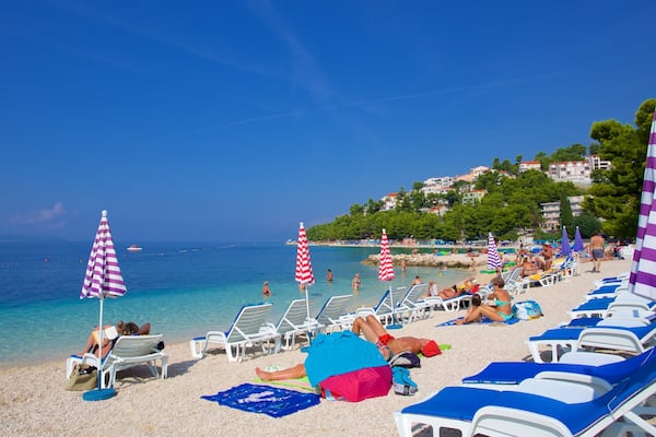 Baska Voda Beach showing a pebble beach as well as a small group of people