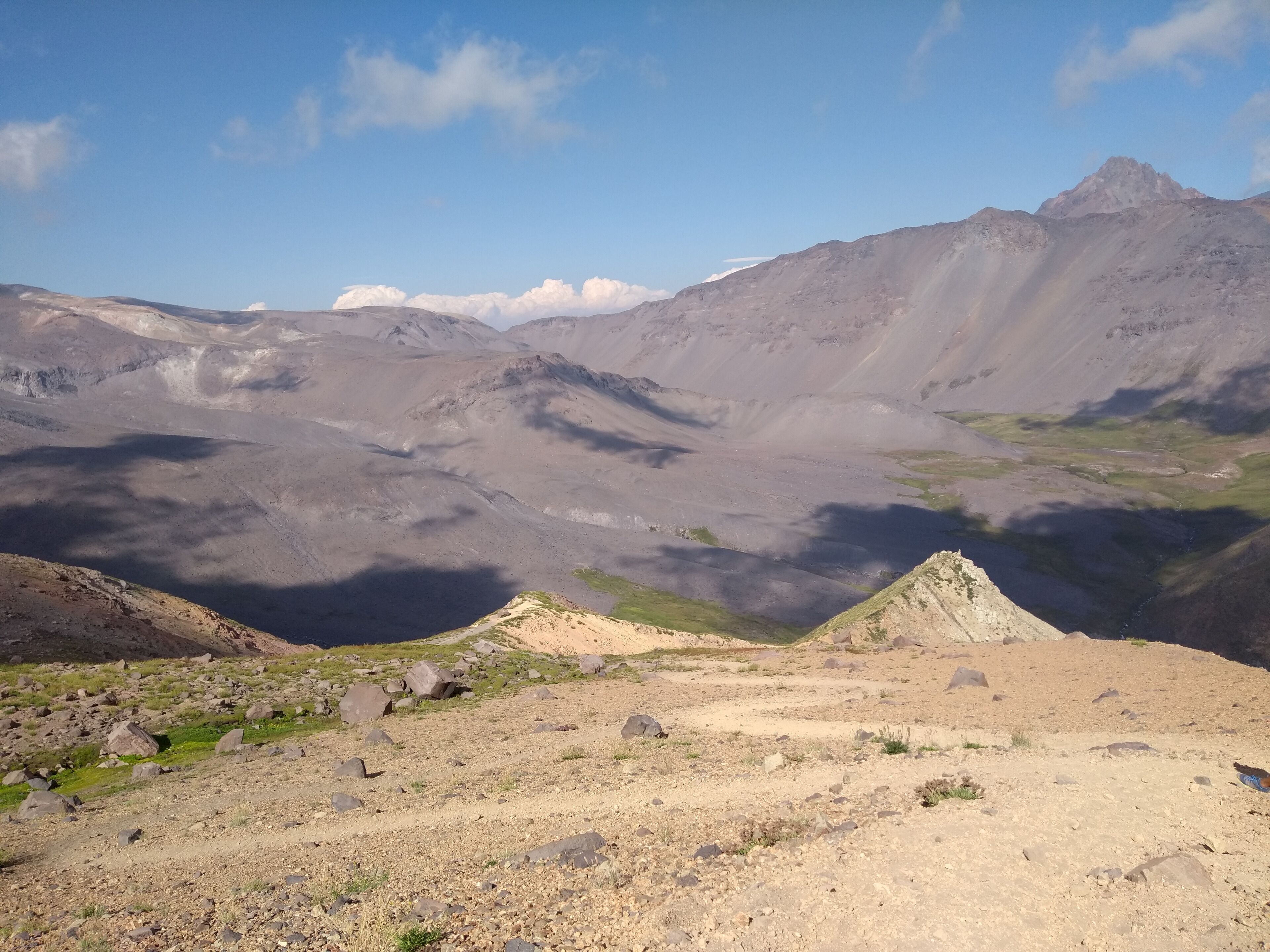 A mountainous landscape with rocky terrain and sparse vegetation.