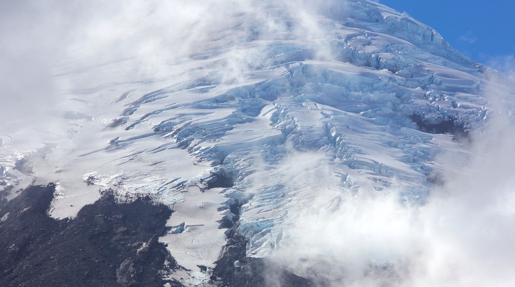 Osorno Volcano Peak featuring mountains, snow and mist or fog