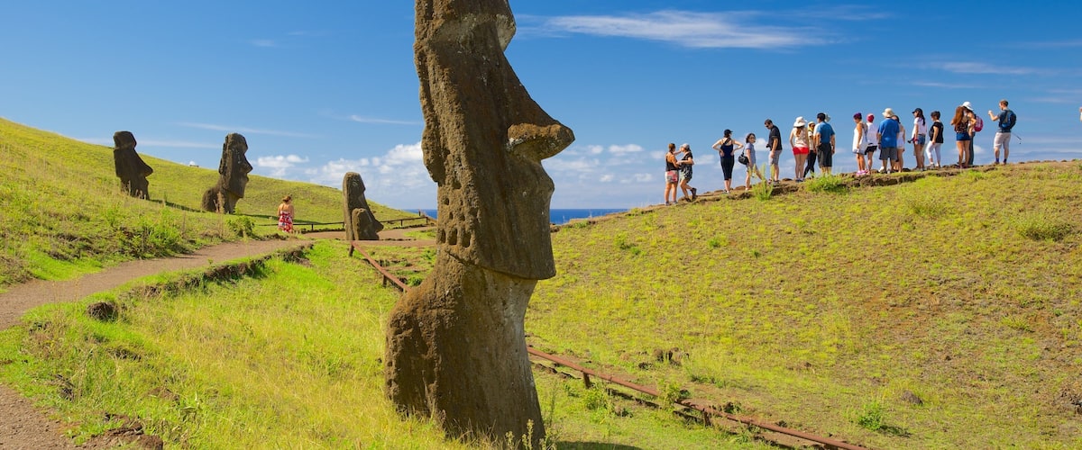 Rano Raraku featuring a statue or sculpture and heritage elements as well as a small group of people