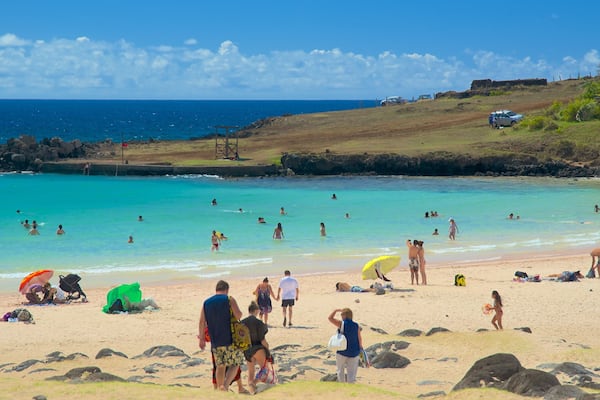 Anakena Beach featuring a sandy beach as well as a small group of people