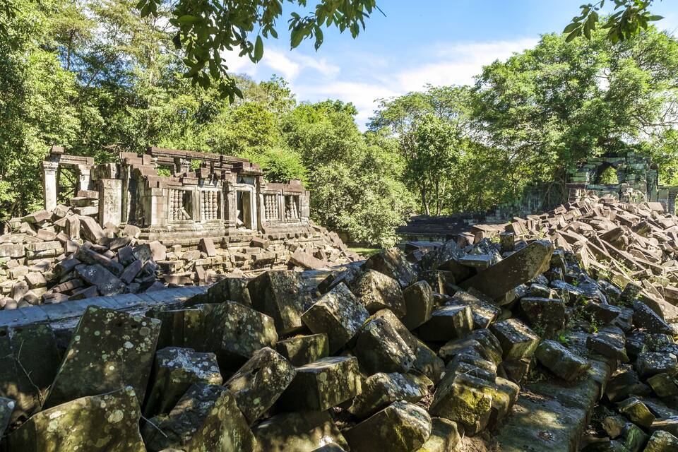 Ancient stone ruins surrounded by lush greenery.