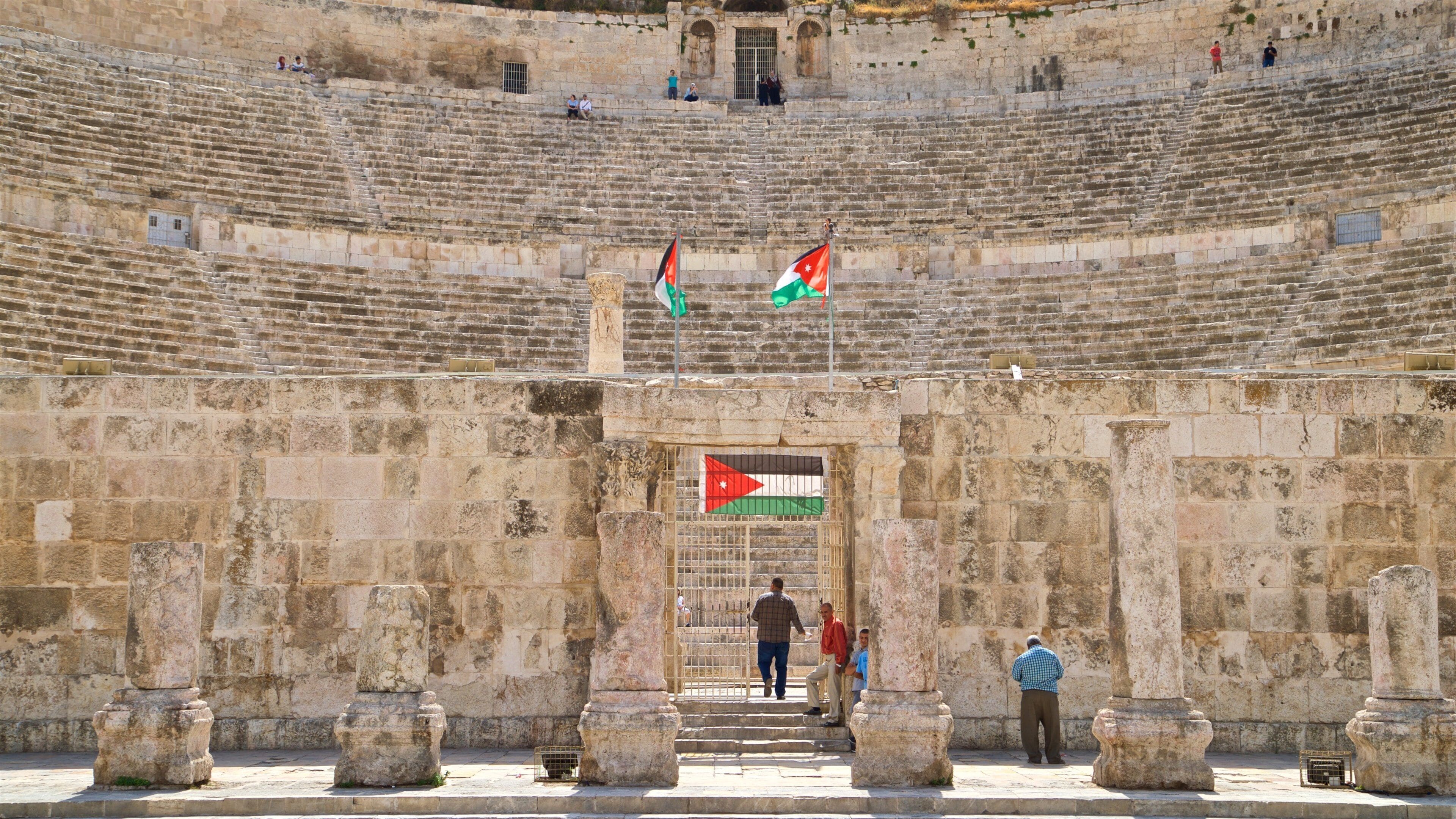 Amman Roman Theater featuring heritage architecture and theater scenes as well as a small group of people