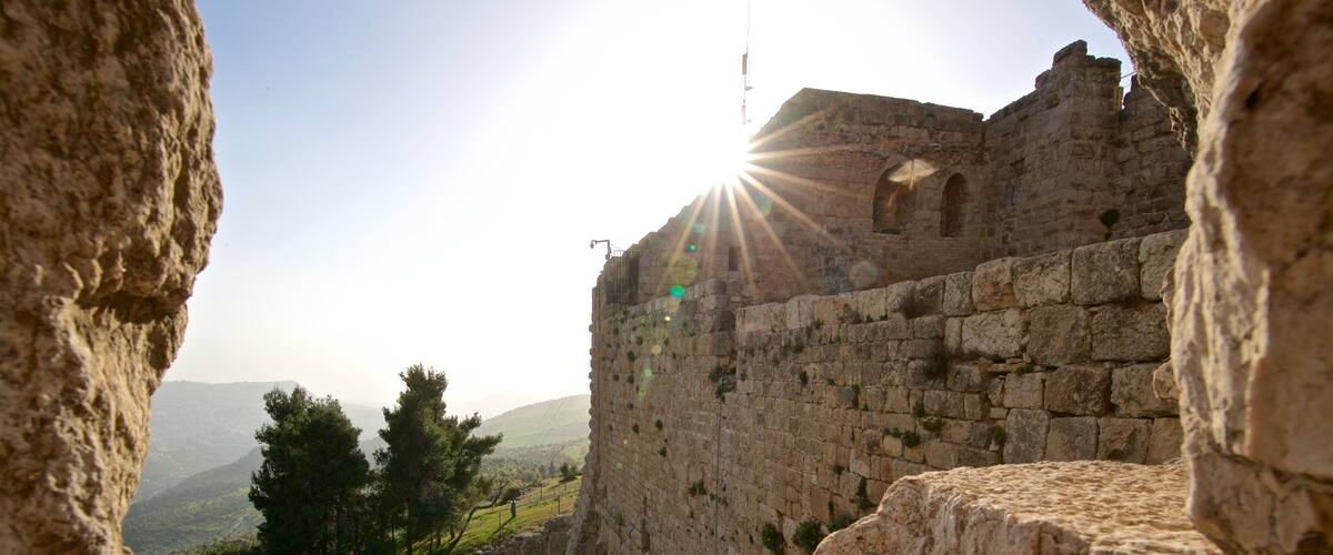 Ajloun Castle showing heritage elements and a sunset