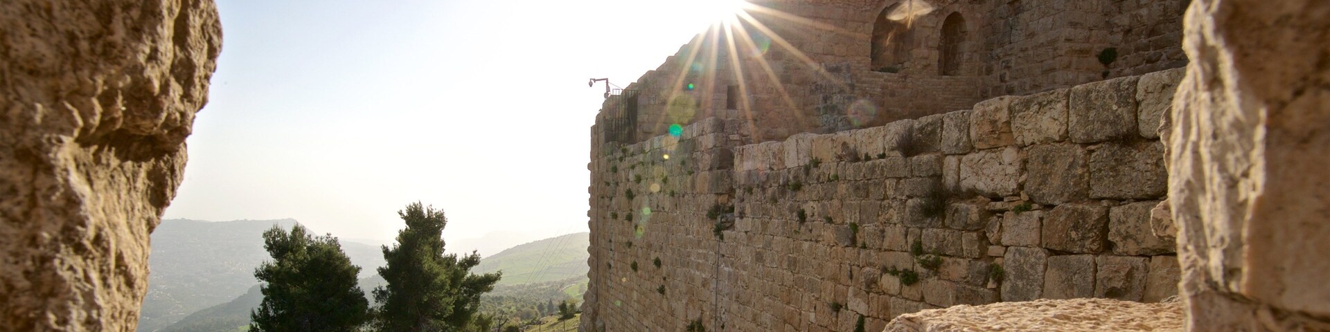 Ajloun Castle showing heritage elements and a sunset