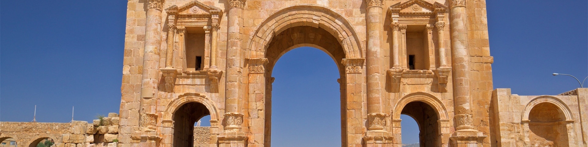 Hadrian\'s Arch which includes heritage architecture as well as a small group of people