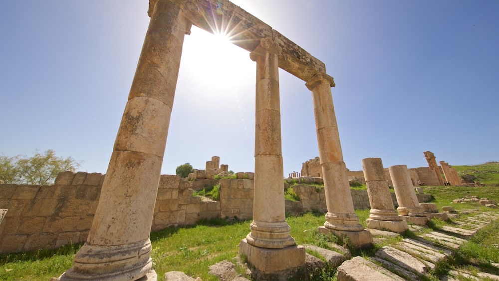 Ancient stone columns and ruins under a clear sky.
