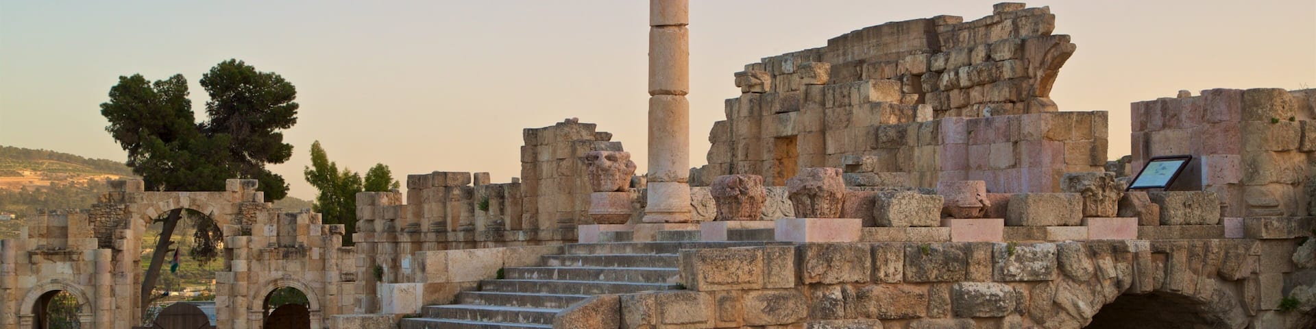 Jerash Archaeological Museum featuring heritage architecture, a sunset and building ruins