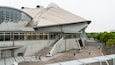 A modern building with a curved roof and large windows.