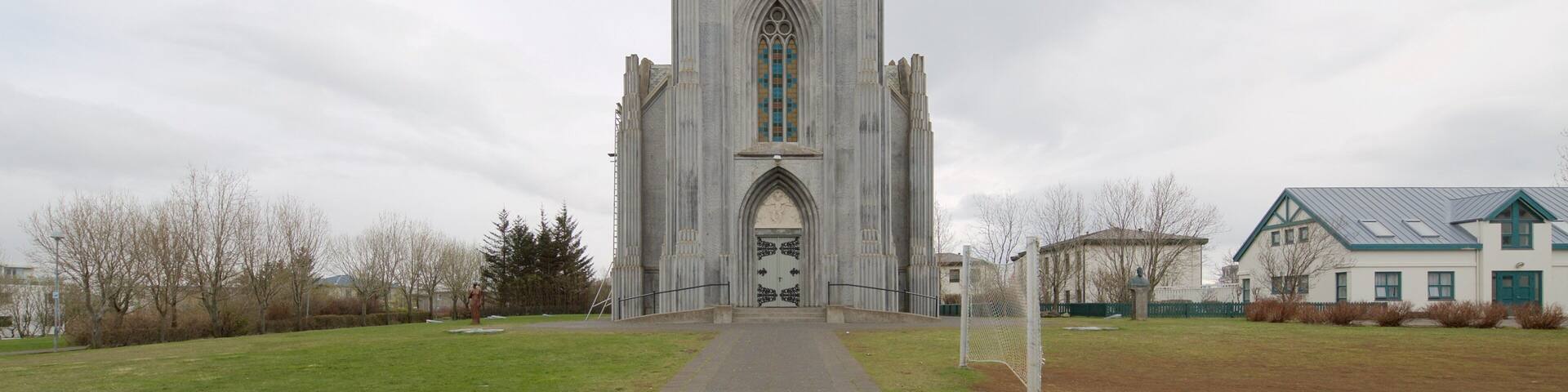 A tall, narrow church with a pointed arch and stained glass windows.
