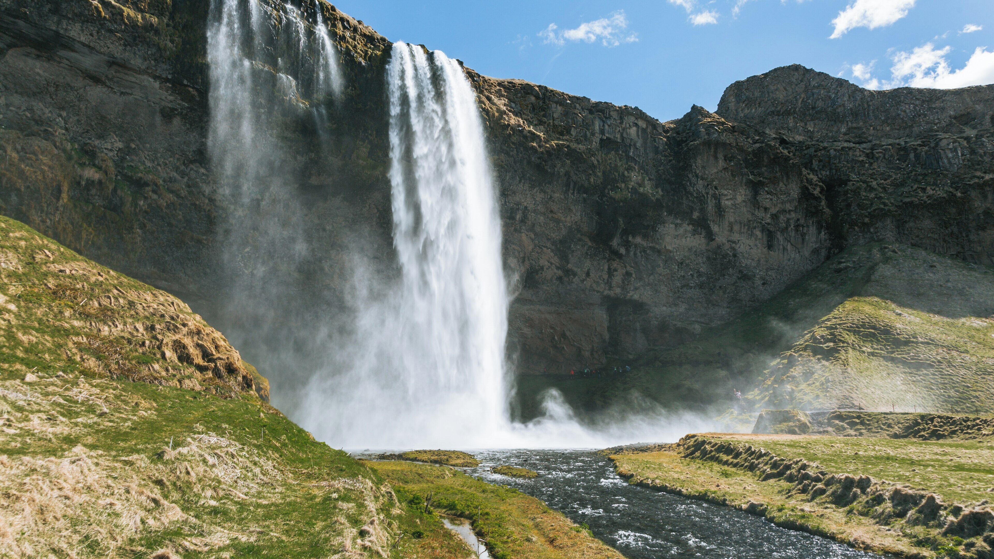 Majestic Seljalandsfoss waterfall cascading down cliffs in Southern Region of Iceland under a clear blue sky