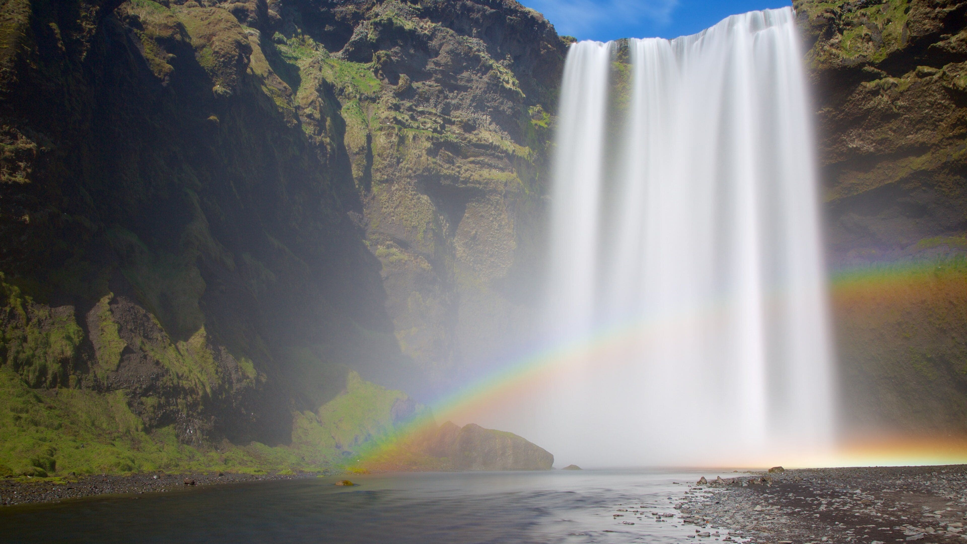 Skogafoss which includes a river or creek, a gorge or canyon and a cascade