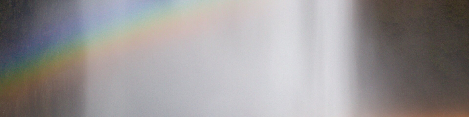 Skogafoss featuring a waterfall as well as a small group of people