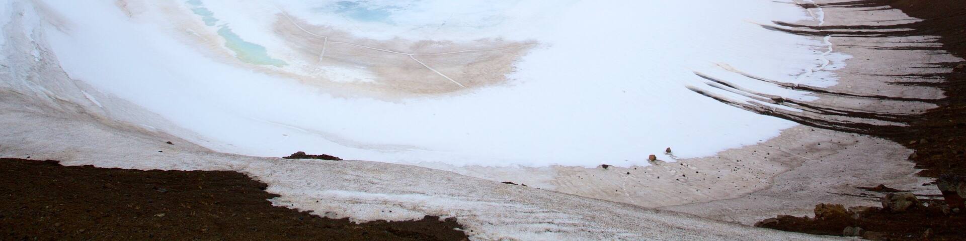 Krafla Volcano showing a hot spring and snow
