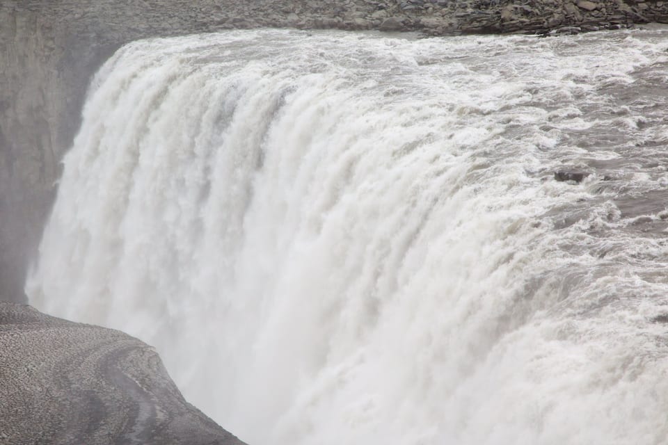 A powerful waterfall cascading over a rocky cliff.