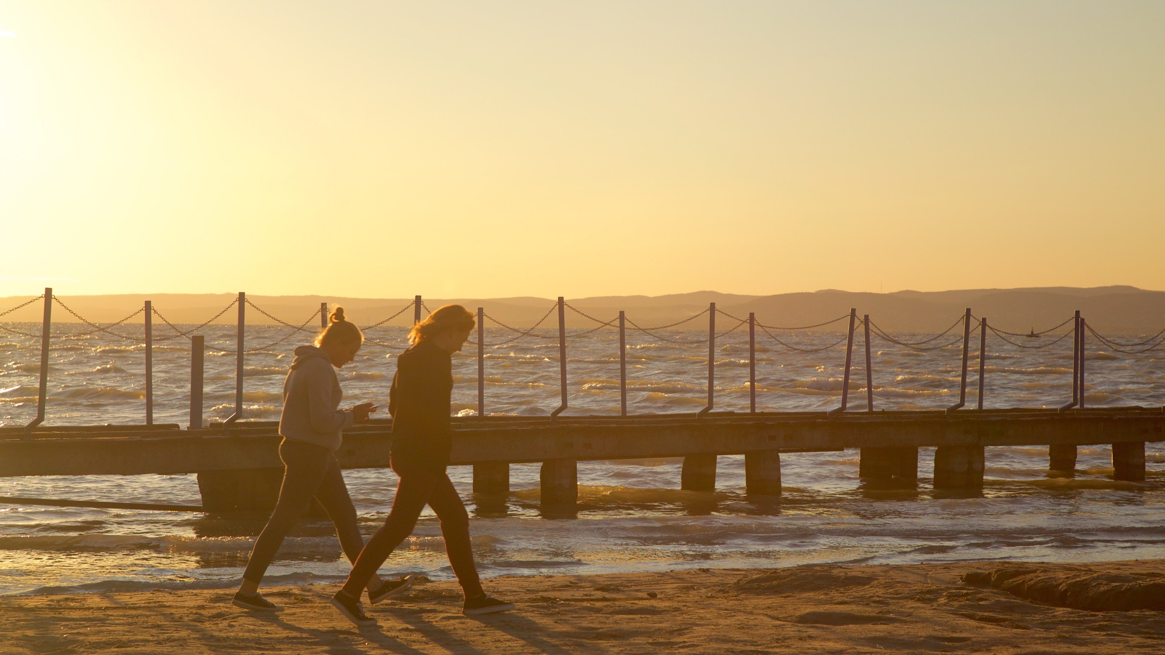 Golden Shore which includes a sandy beach, a sunset and views