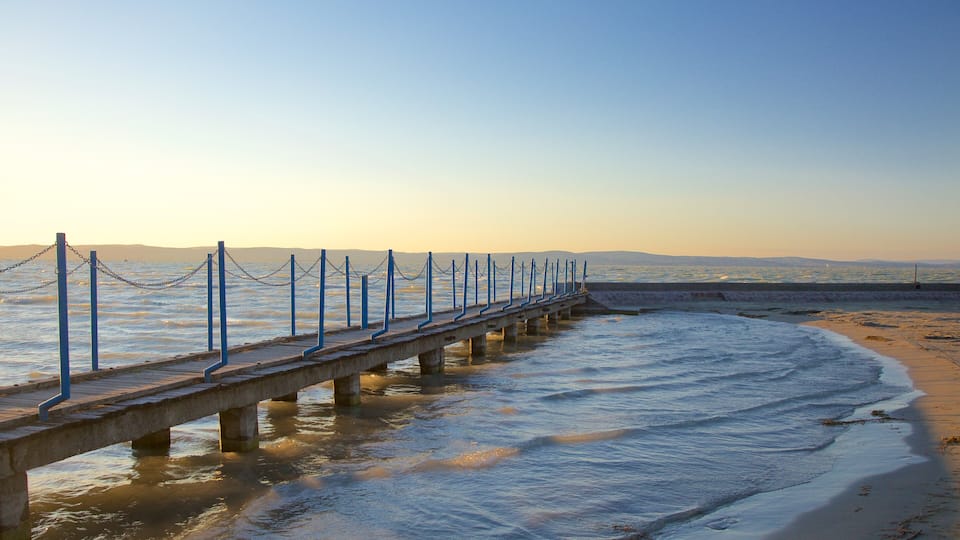 Golden Shore which includes a sandy beach, views and a sunset