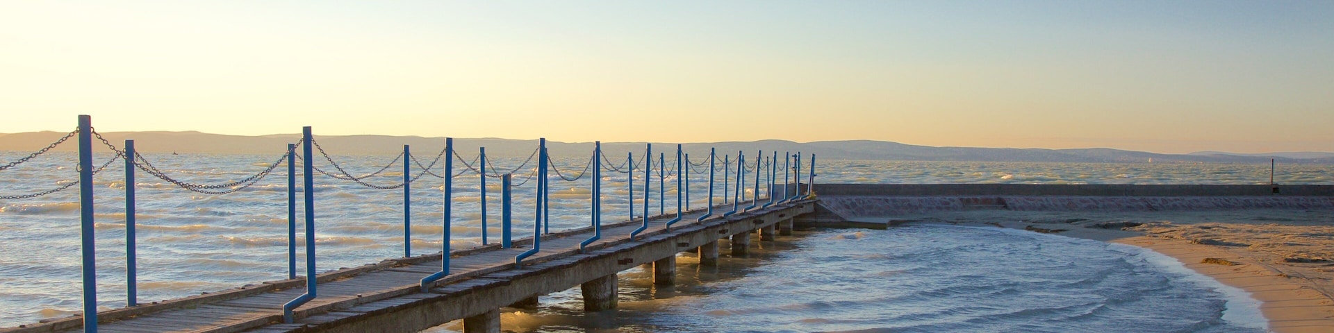 Golden Shore which includes a sandy beach, views and a sunset