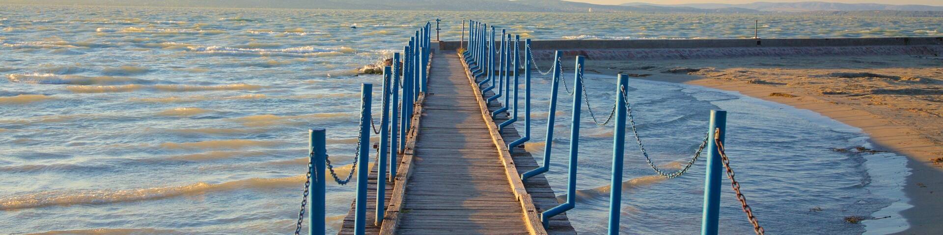 Golden Shore which includes a beach, a sunset and views