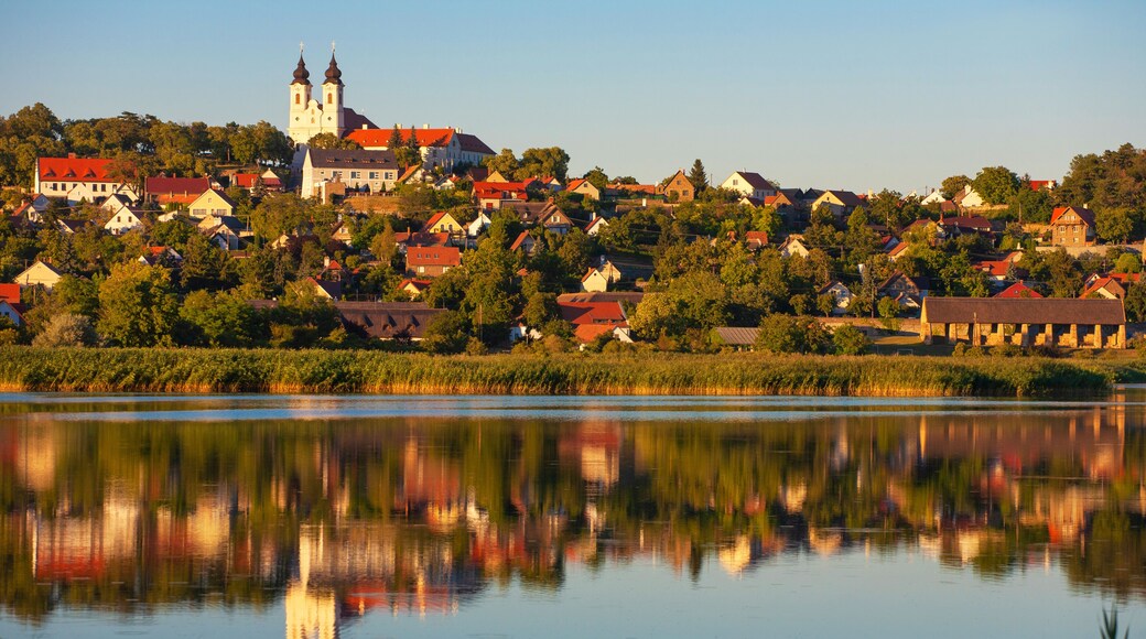 Tihany village and the Benedictian abbey in warm sunset colors with the inner lake in the front and a beautiful refletion on water at lake Balaton in Hungary