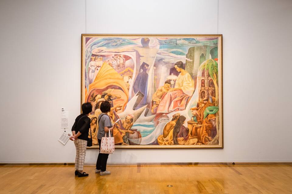 A large mural in an art gallery with people observing it.