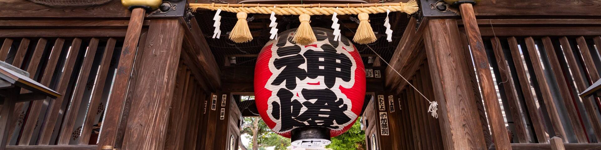 A traditional wooden structure with ornate decorations and hanging lanterns.