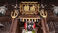 A traditional wooden structure with ornate decorations and hanging lanterns.