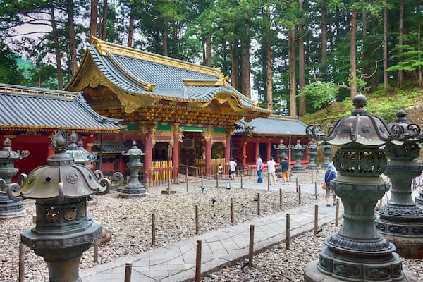 Ein traditioneller Tempel mit aufwendiger Architektur, umgeben von einem bewaldeten Gebiet.